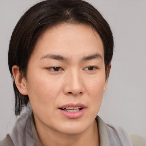 Joyful asian young-adult female with medium  brown hair and brown eyes
