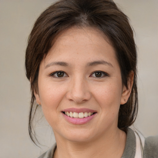 Joyful white young-adult female with medium  brown hair and brown eyes