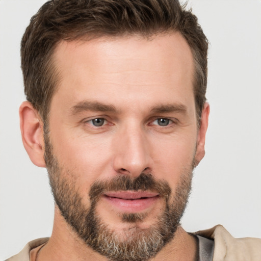 Joyful white adult male with short  brown hair and brown eyes