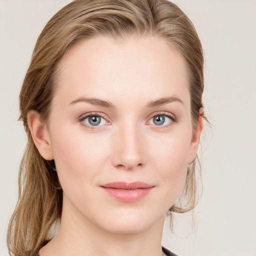 Joyful white young-adult female with medium  brown hair and blue eyes