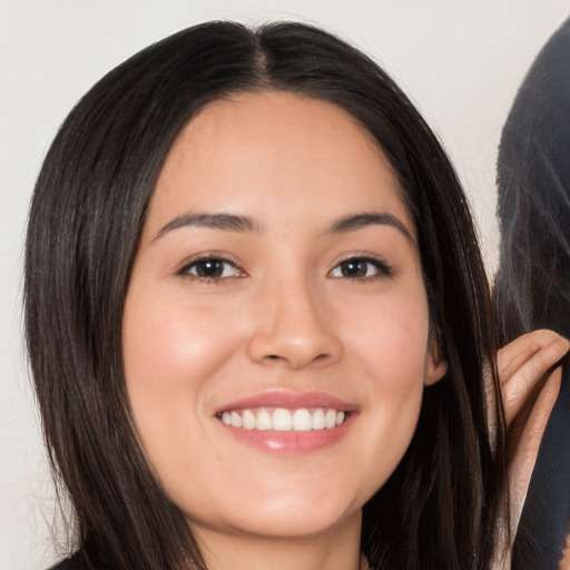 Joyful white young-adult female with long  black hair and brown eyes