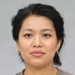 Joyful asian young-adult female with medium  brown hair and brown eyes