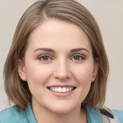 Joyful white young-adult female with medium  brown hair and blue eyes