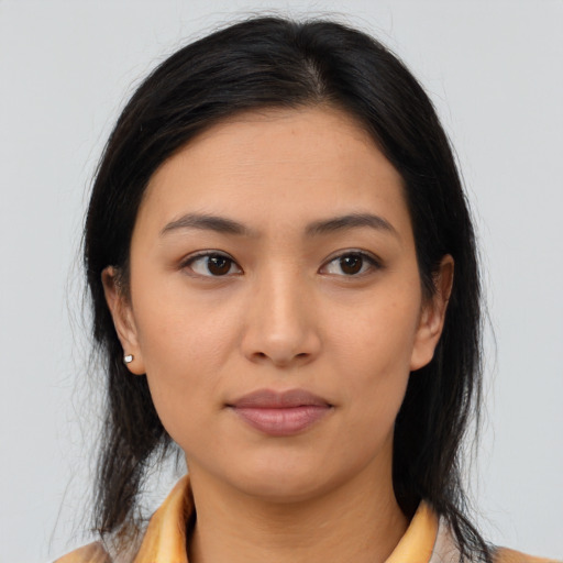 Joyful latino young-adult female with medium  brown hair and brown eyes