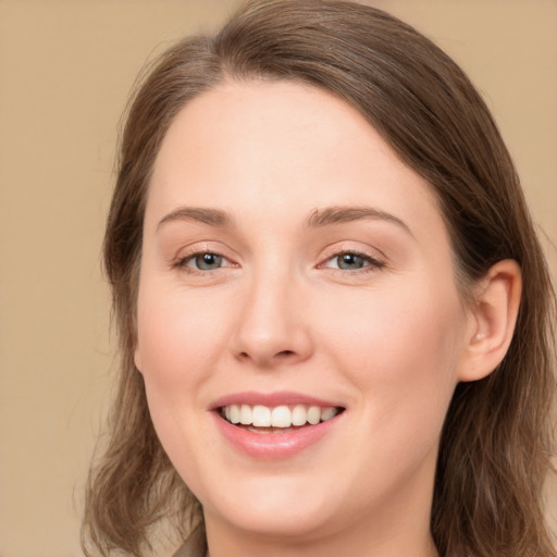 Joyful white young-adult female with long  brown hair and grey eyes