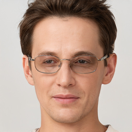 Joyful white adult male with short  brown hair and grey eyes