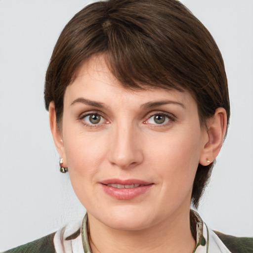 Joyful white young-adult female with medium  brown hair and grey eyes