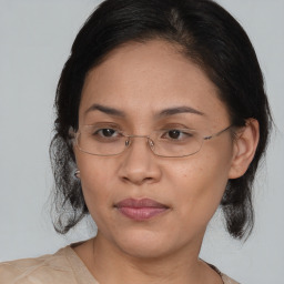 Joyful asian adult female with medium  brown hair and brown eyes