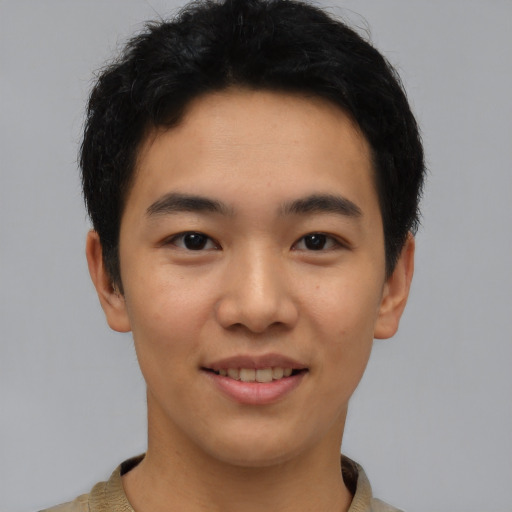 Joyful asian young-adult male with short  black hair and brown eyes