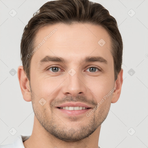 Joyful white young-adult male with short  brown hair and grey eyes