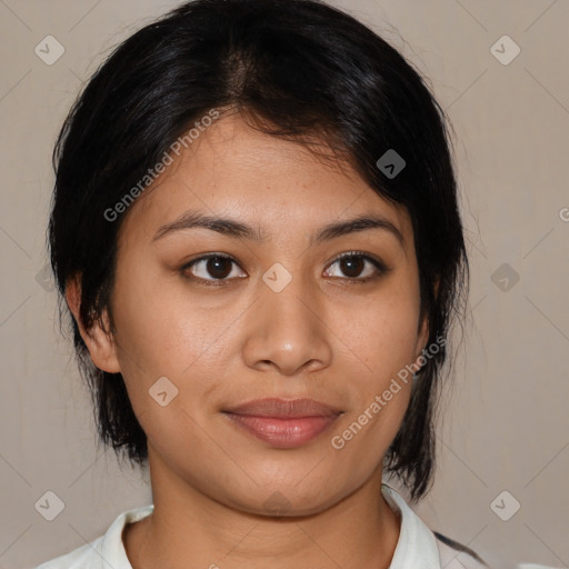 Joyful latino young-adult female with medium  brown hair and brown eyes