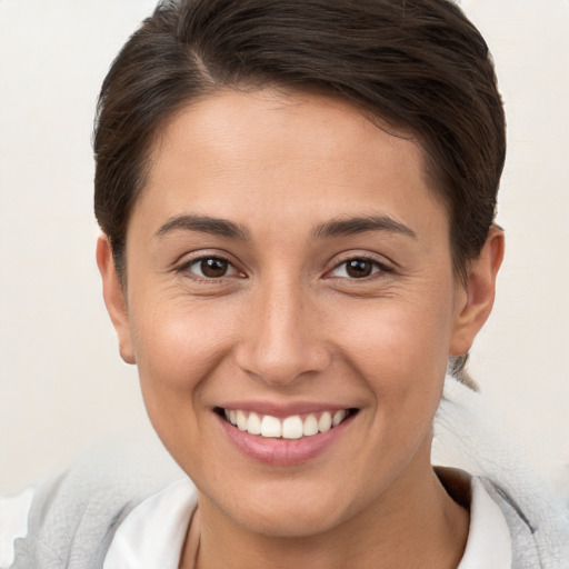 Joyful white young-adult female with short  brown hair and brown eyes