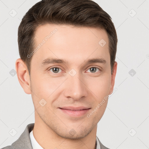 Joyful white young-adult male with short  brown hair and grey eyes