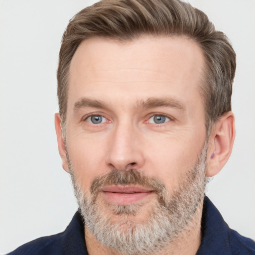 Joyful white adult male with short  brown hair and grey eyes