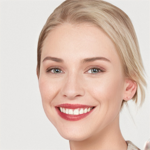 Joyful white young-adult female with medium  brown hair and blue eyes