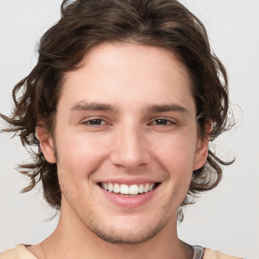 Joyful white young-adult male with medium  brown hair and brown eyes