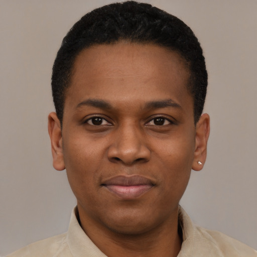 Joyful black young-adult male with short  black hair and brown eyes