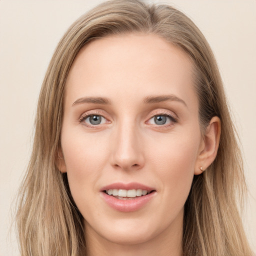 Joyful white young-adult female with long  brown hair and blue eyes