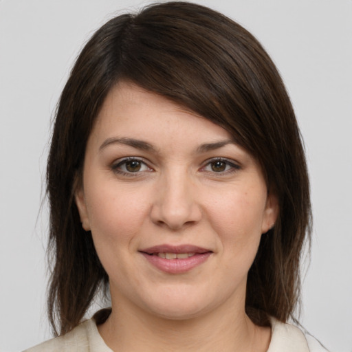 Joyful white young-adult female with medium  brown hair and grey eyes