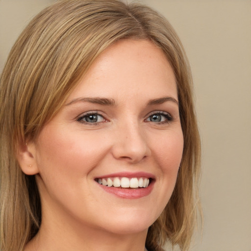 Joyful white young-adult female with long  brown hair and green eyes