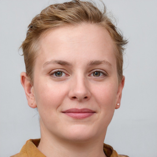 Joyful white young-adult female with short  brown hair and blue eyes