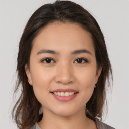 Joyful asian young-adult female with medium  brown hair and brown eyes