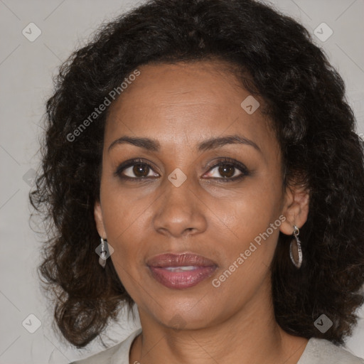 Joyful black adult female with medium  brown hair and brown eyes