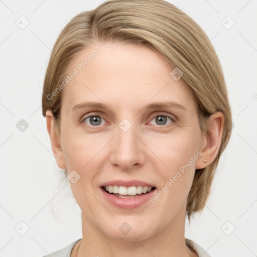 Joyful white young-adult female with medium  brown hair and grey eyes