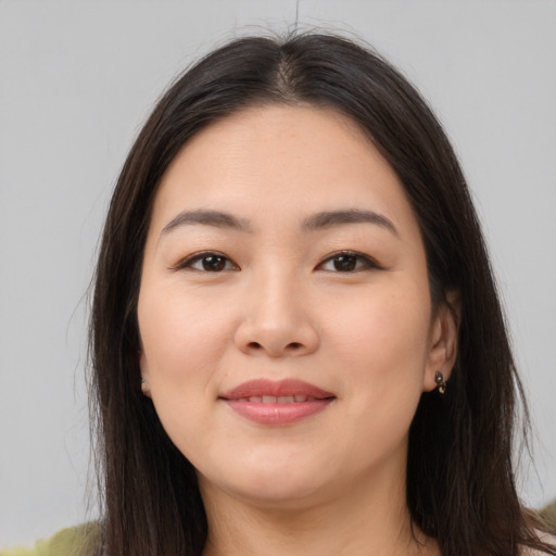 Joyful asian young-adult female with long  brown hair and brown eyes