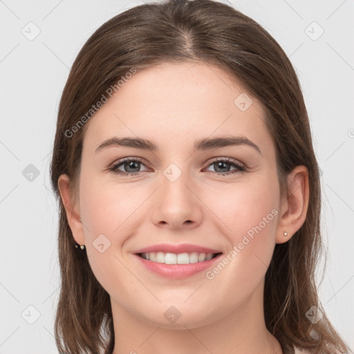 Joyful white young-adult female with long  brown hair and grey eyes