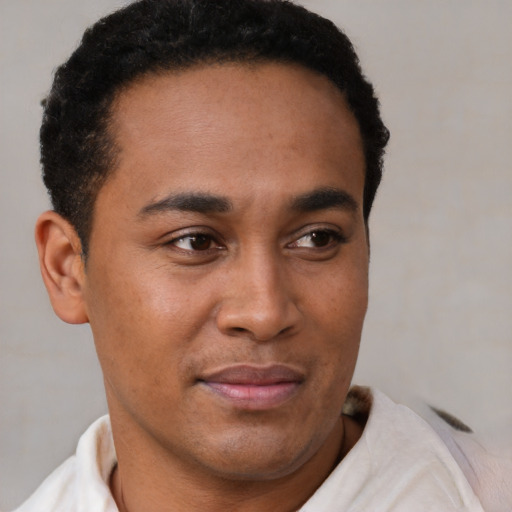 Joyful latino young-adult male with short  brown hair and brown eyes