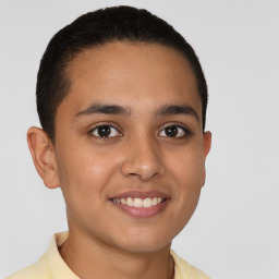 Joyful latino young-adult male with short  brown hair and brown eyes