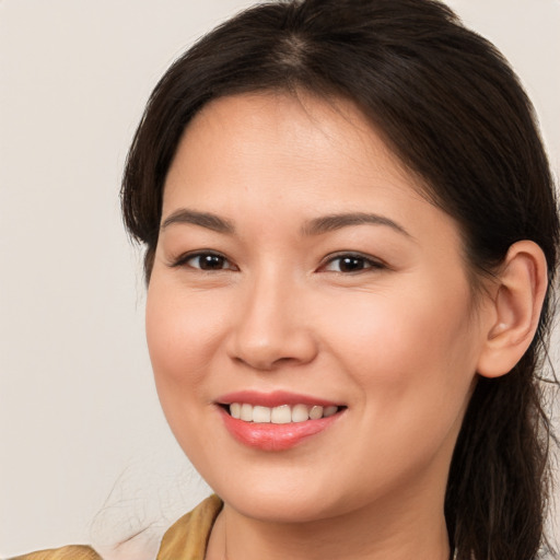 Joyful white young-adult female with long  brown hair and brown eyes