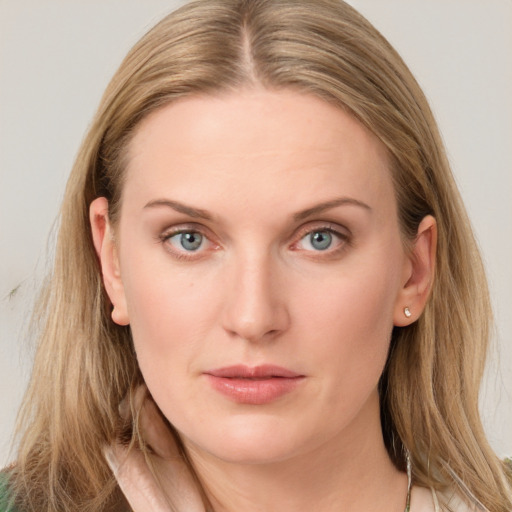 Joyful white young-adult female with long  brown hair and blue eyes