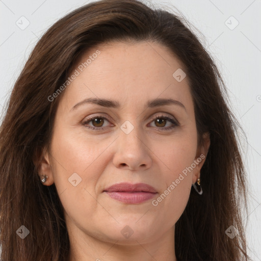 Joyful white adult female with long  brown hair and brown eyes