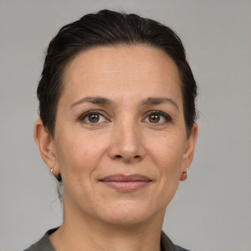 Joyful white adult female with short  brown hair and grey eyes