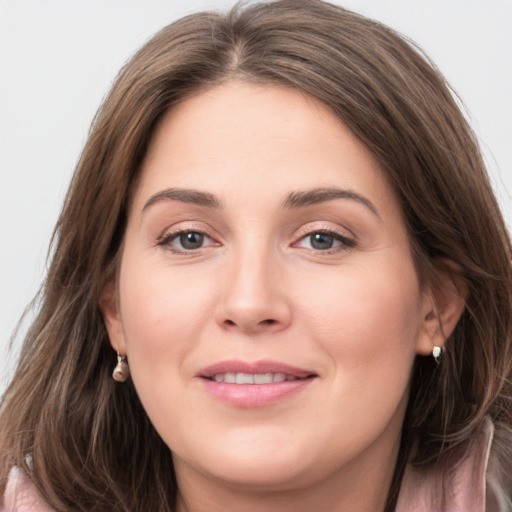 Joyful white young-adult female with long  brown hair and grey eyes