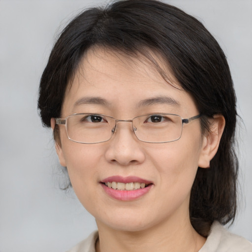 Joyful white adult female with medium  brown hair and brown eyes