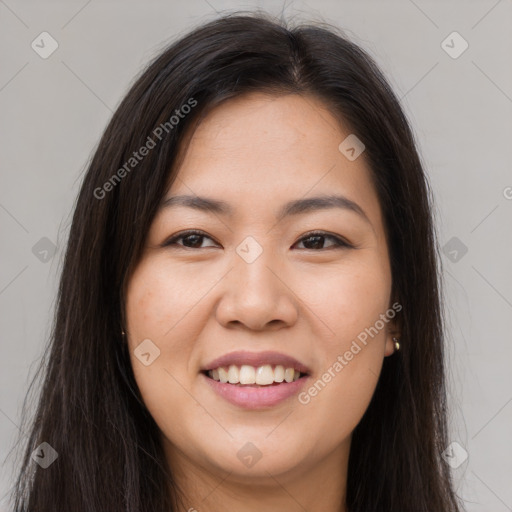 Joyful asian young-adult female with long  brown hair and brown eyes