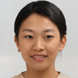 Joyful asian young-adult female with short  black hair and brown eyes