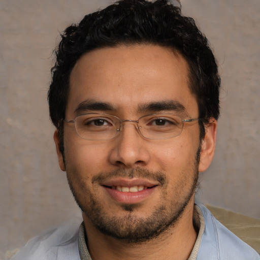 Joyful asian young-adult male with short  black hair and brown eyes