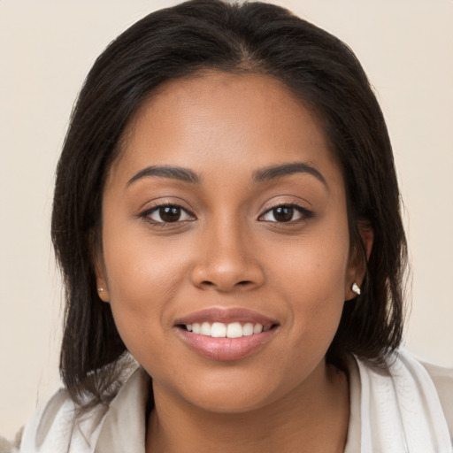 Joyful latino young-adult female with medium  brown hair and brown eyes