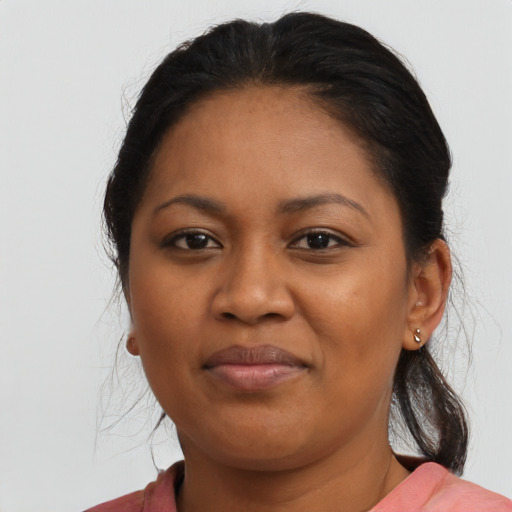 Joyful black young-adult female with medium  brown hair and brown eyes