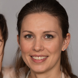 Joyful white adult female with medium  brown hair and brown eyes