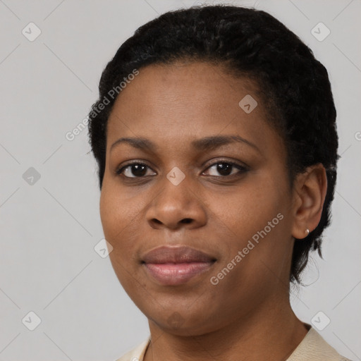 Joyful black young-adult female with short  black hair and brown eyes