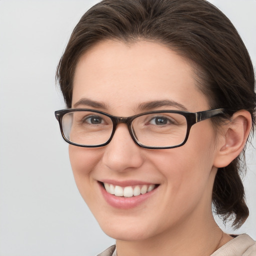 Joyful white young-adult female with medium  brown hair and brown eyes