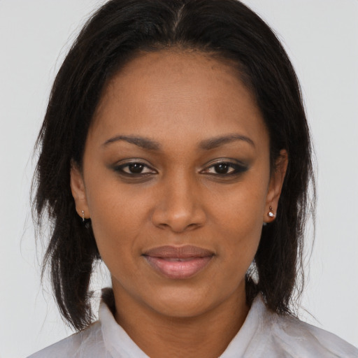 Joyful black young-adult female with medium  brown hair and brown eyes