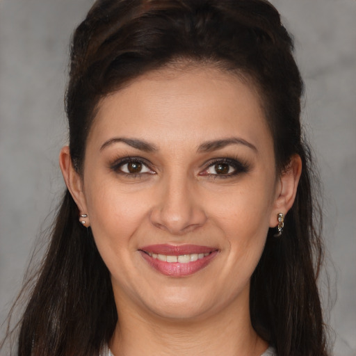 Joyful white young-adult female with long  brown hair and brown eyes