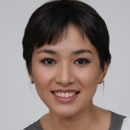 Joyful asian young-adult female with medium  black hair and brown eyes