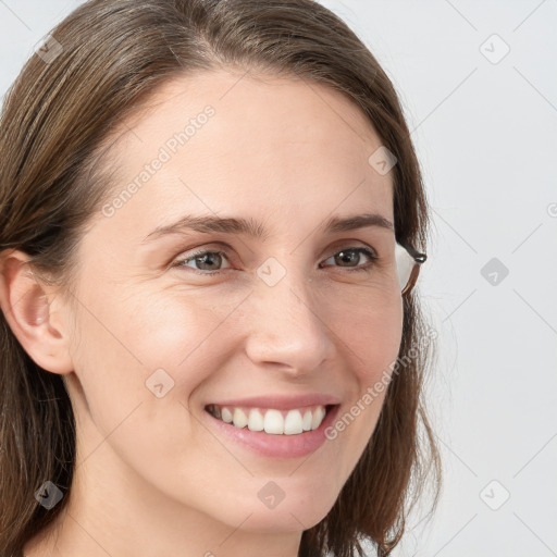 Joyful white young-adult female with long  brown hair and grey eyes